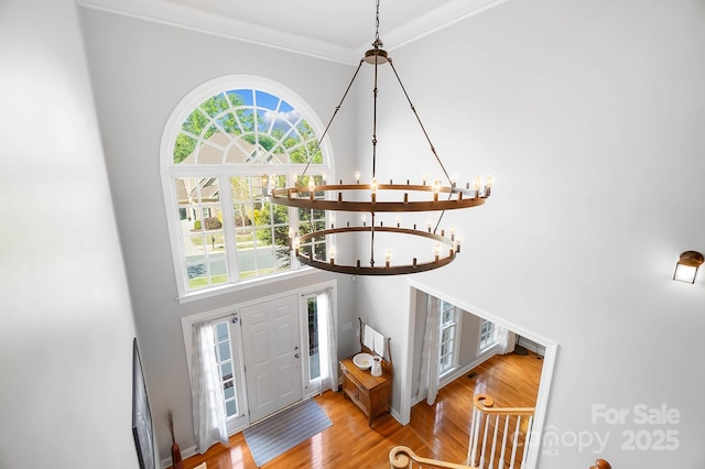16532 Flintrock Falls Ln, Charlotte, NC 28278 - entrance foyer with wood finished floors, a towering ceiling, a notable chandelier, and crown molding