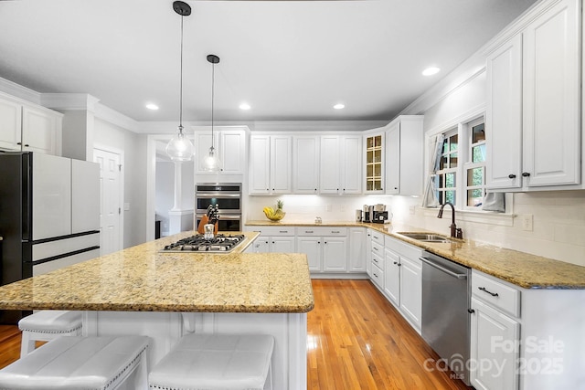 16532 Flintrock Falls Ln, Charlotte, NC 28278 - kitchen with white cabinets, a kitchen bar, stainless steel appliances, and a sink