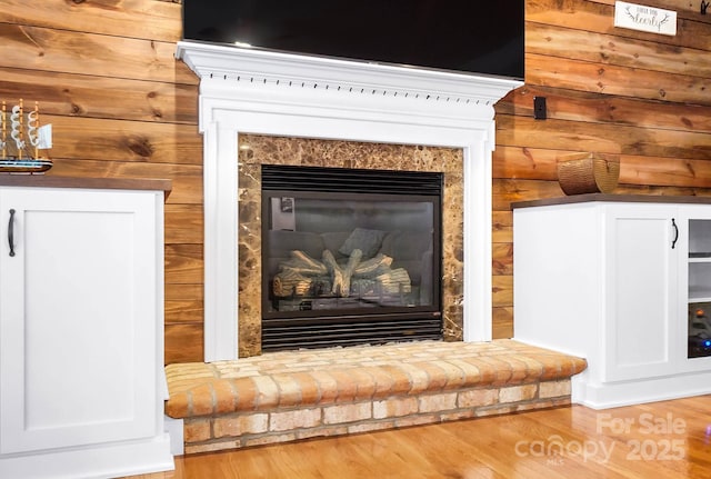 16532 Flintrock Falls Ln, Charlotte, NC 28278 - details with a glass covered fireplace, wood finished floors, and wooden walls