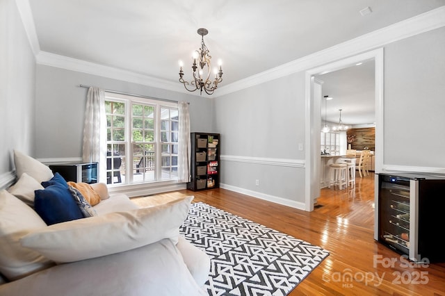 16532 Flintrock Falls Ln, Charlotte, NC 28278 - living area featuring a chandelier, wood finished floors, crown molding, and wine cooler