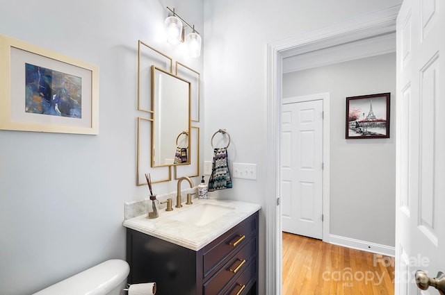16532 Flintrock Falls Ln, Charlotte, NC 28278 - bathroom with wood finished floors, vanity, baseboards, toilet, and ornamental molding