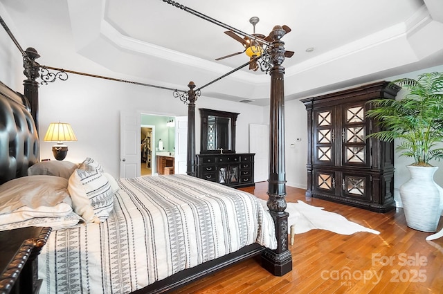 16532 Flintrock Falls Ln, Charlotte, NC 28278 - bedroom with a tray ceiling, wood finished floors, ceiling fan, and ornamental molding