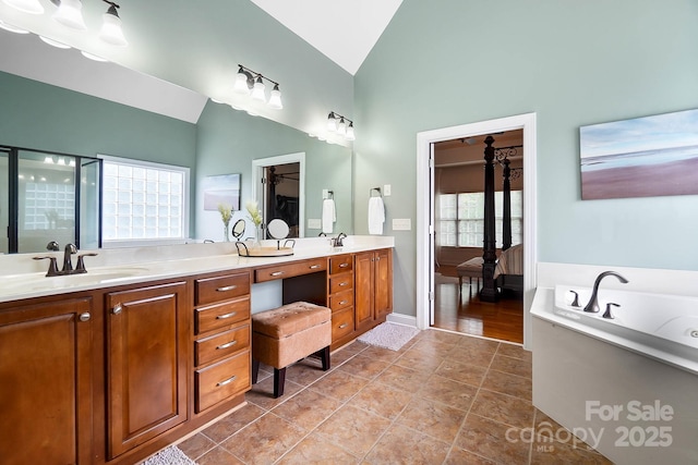 16532 Flintrock Falls Ln, Charlotte, NC 28278 - ensuite bathroom featuring double vanity, a garden tub, high vaulted ceiling, and a sink
