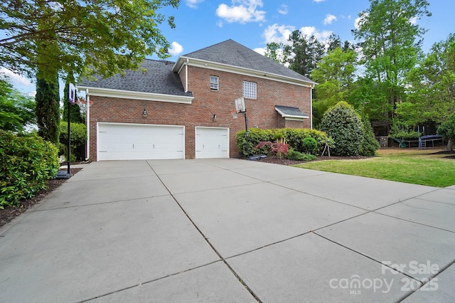 16532 Flintrock Falls Ln, Charlotte, NC 28278 - view of home's exterior with concrete driveway, brick siding, a yard, and a shingled roof