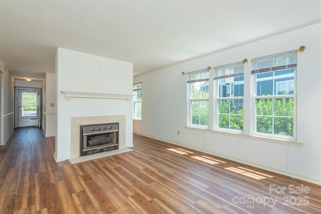 3101 Idle Hour Dr, Asheville, NC 28806 - unfurnished living room featuring wood finished floors, a fireplace, and a textured ceiling