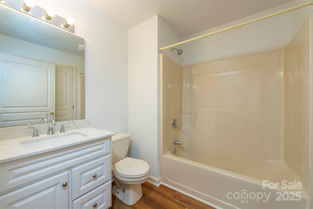 3101 Idle Hour Dr, Asheville, NC 28806 - bathroom featuring vanity, wood finished floors, shower / bathtub combination, and a textured ceiling