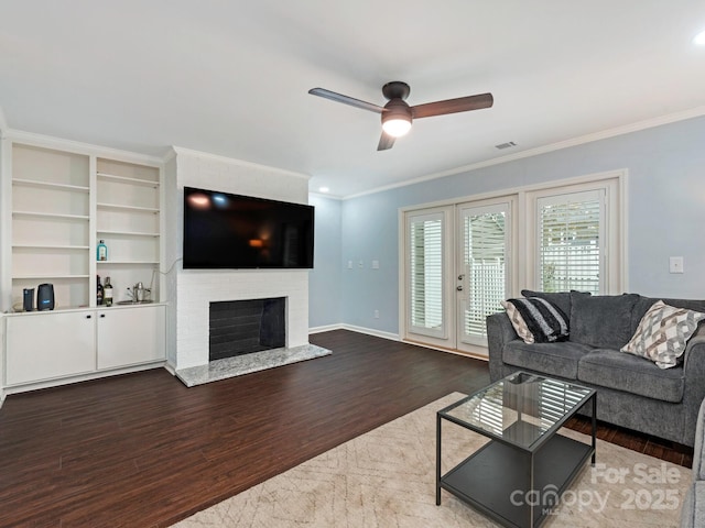 8251 Tradd Ct, Charlotte, NC 28210 - living room featuring wood finished floors, ceiling fan, crown molding, a fireplace, and baseboards