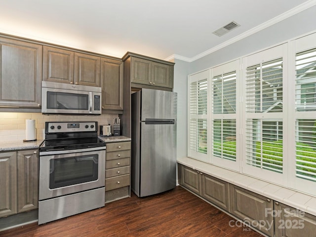 8251 Tradd Ct, Charlotte, NC 28210 - kitchen with appliances with stainless steel finishes, ornamental molding, decorative backsplash, and dark wood-style floors