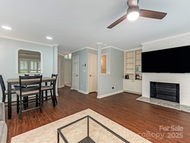 8251 Tradd Ct, Charlotte, NC 28210 - living area with dark wood-type flooring, ceiling fan, a fireplace, baseboards, and ornamental molding