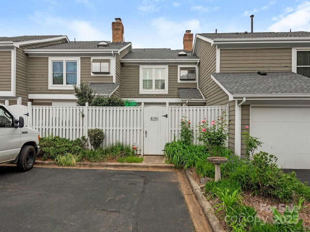 8251 Tradd Ct, Charlotte, NC 28210 - townhome / multi-family property with a gate, a chimney, and a garage