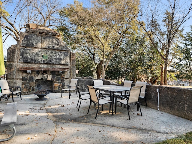 8251 Tradd Ct, Charlotte, NC 28210 - view of patio / terrace with outdoor dining space and an outdoor stone fireplace