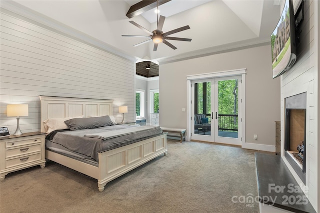 carpeted bedroom with french doors, access to exterior, a fireplace with raised hearth, ceiling fan, and ornamental molding
