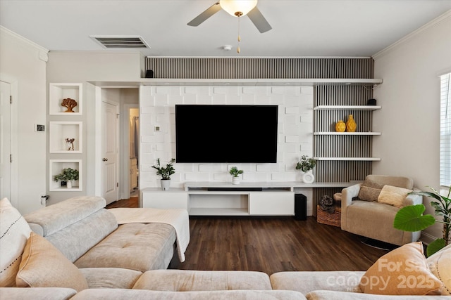 living room with visible vents, wood finished floors, ceiling fan, and crown molding