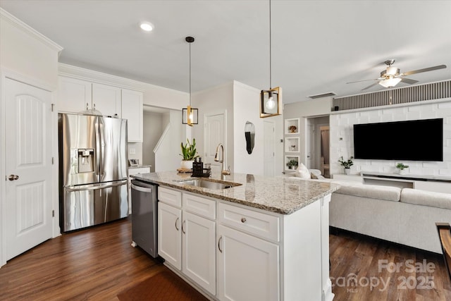 kitchen featuring a ceiling fan, a sink, appliances with stainless steel finishes, and dark wood-style flooring