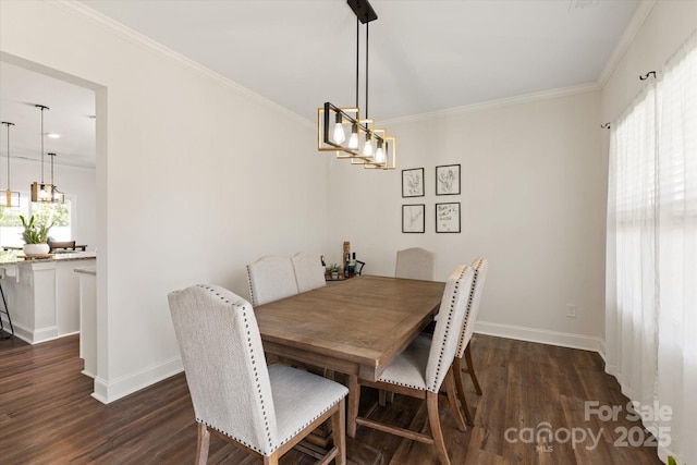 dining area featuring crown molding, an inviting chandelier, baseboards, and dark wood finished floors