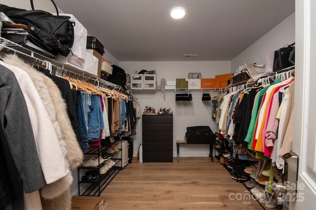 spacious closet featuring visible vents and wood finished floors