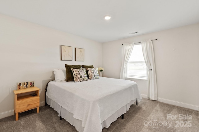 carpeted bedroom featuring visible vents and baseboards