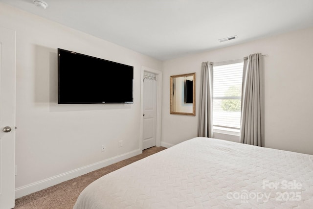 bedroom featuring baseboards, visible vents, and carpet floors