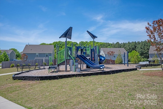 community jungle gym with fence and a lawn