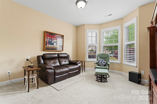 carpeted living room featuring baseboards and visible vents