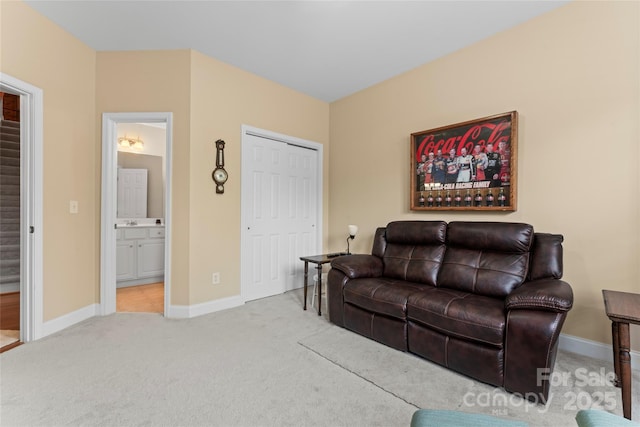 living area with baseboards and carpet