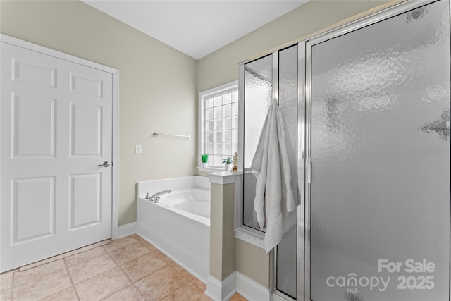 full bathroom featuring a bath, tile patterned floors, baseboards, and a stall shower