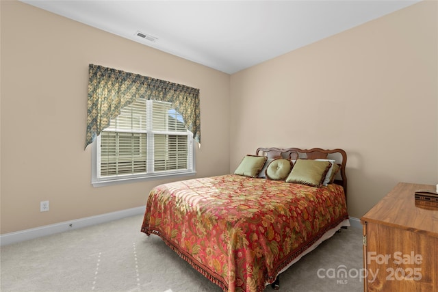 carpeted bedroom with baseboards and visible vents