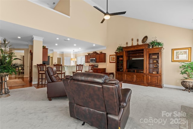 living area with crown molding, ceiling fan, light carpet, baseboards, and recessed lighting