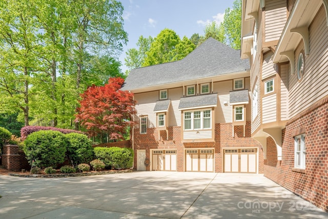 view of front of house featuring a garage, brick siding, and concrete driveway