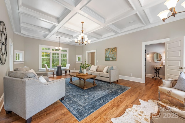 living area with coffered ceiling, wood finished floors, beamed ceiling, baseboards, and a notable chandelier