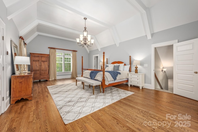 bedroom with vaulted ceiling with beams, wood finished floors, and a chandelier