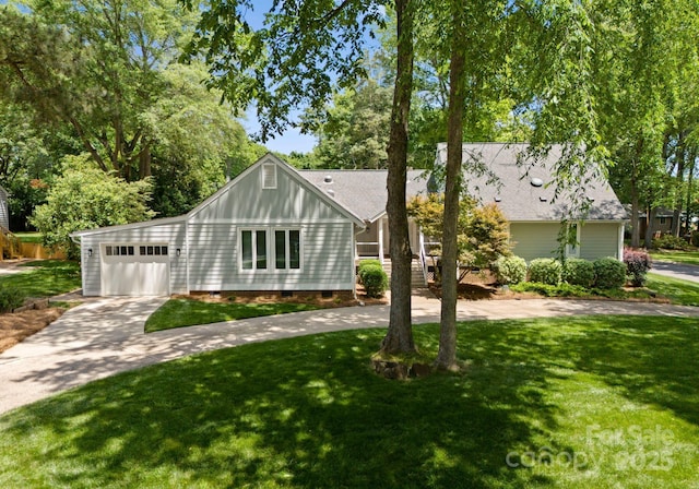 view of front of property featuring concrete driveway, a garage, a front yard, and crawl space