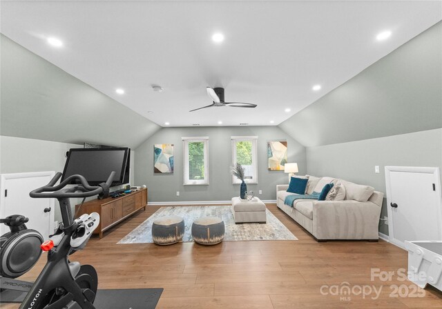 living area with lofted ceiling, ceiling fan, light wood-style flooring, baseboards, and recessed lighting