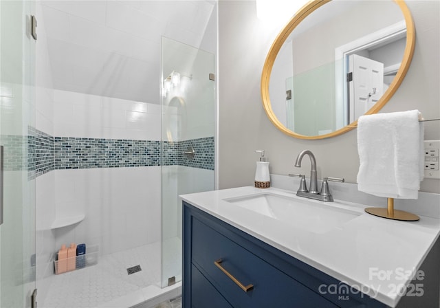bathroom featuring a stall shower and vanity