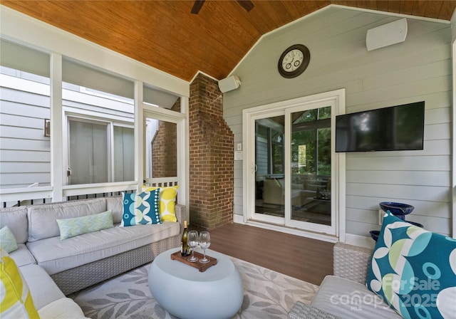 living room featuring wood ceiling, wood finished floors, lofted ceiling, and wooden walls