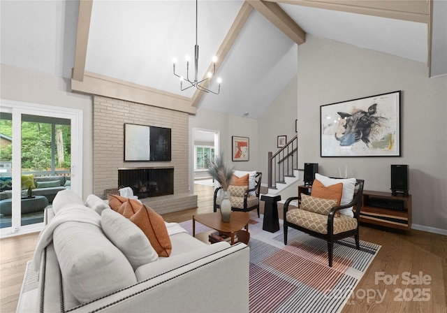 living room featuring high vaulted ceiling, beamed ceiling, wood finished floors, stairs, and a chandelier