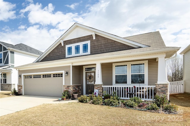 3100 Cheyney Park Dr, Charlotte, NC 28269 - craftsman house with a garage, a porch, driveway, and stone siding