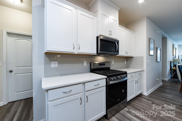 3100 Cheyney Park Dr, Charlotte, NC 28269 - kitchen with tasteful backsplash, dark wood-style floors, white cabinetry, light countertops, and stainless steel appliances