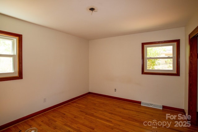200 Butler Rd, Forest City, NC 28043 - unfurnished room with baseboards, wood finished floors, and visible vents