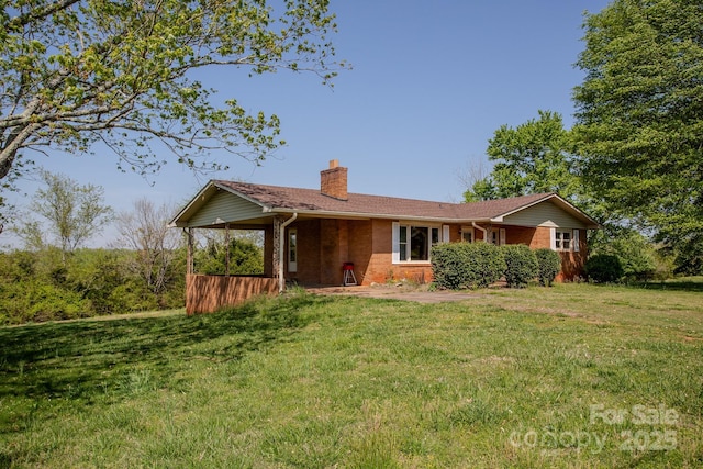 ranch-style home featuring a chimney and a front lawn