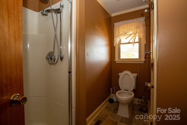 bathroom with toilet, baseboards, visible vents, a shower stall, and ornamental molding