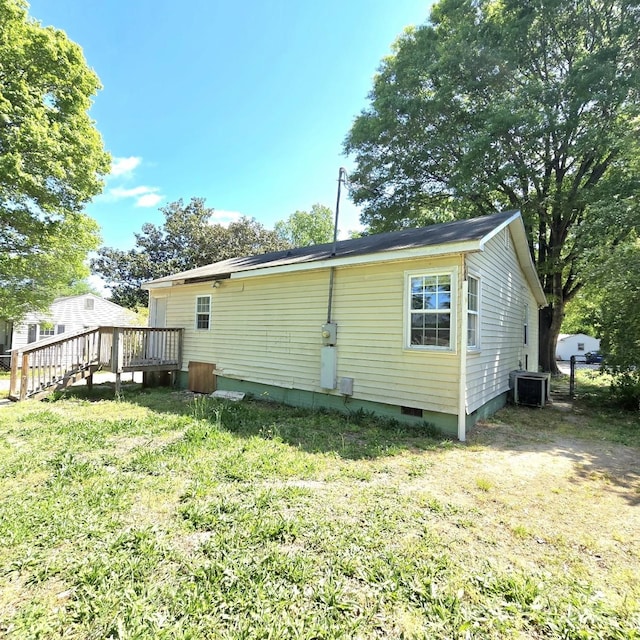 back of house with a deck, a yard, crawl space, and central AC