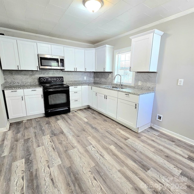 kitchen with stainless steel microwave, white cabinetry, black electric range, ornamental molding, and backsplash