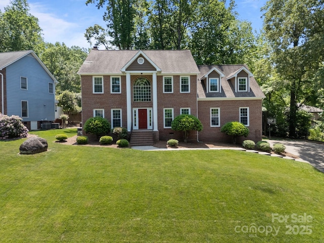9000 Stourbridge Dr, Huntersville, NC 28078 - greek revival house featuring cooling unit, a front yard, and brick siding