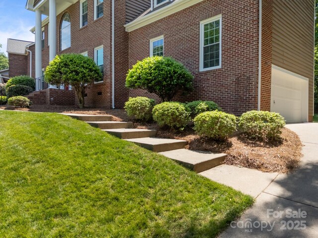 9000 Stourbridge Dr, Huntersville, NC 28078 - view of side of property featuring a yard, brick siding, driveway, and a garage
