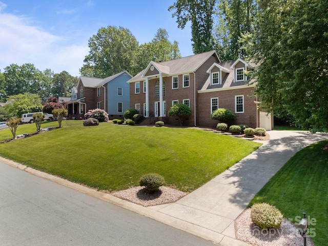 9000 Stourbridge Dr, Huntersville, NC 28078 - view of front of property featuring concrete driveway, brick siding, a front yard, and a garage