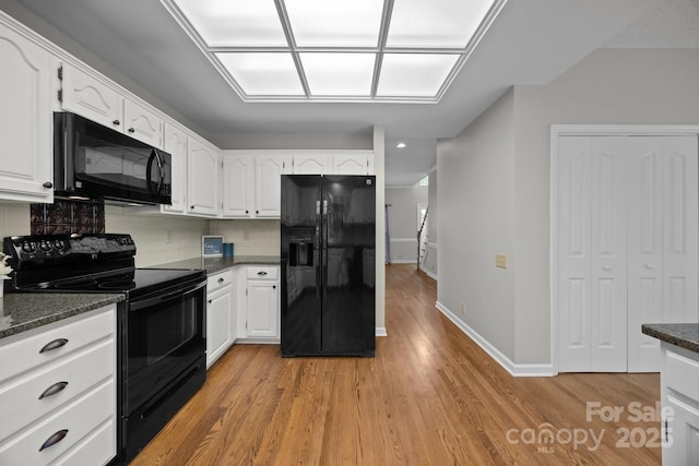 9000 Stourbridge Dr, Huntersville, NC 28078 - kitchen featuring tasteful backsplash, baseboards, black appliances, light wood finished floors, and white cabinetry