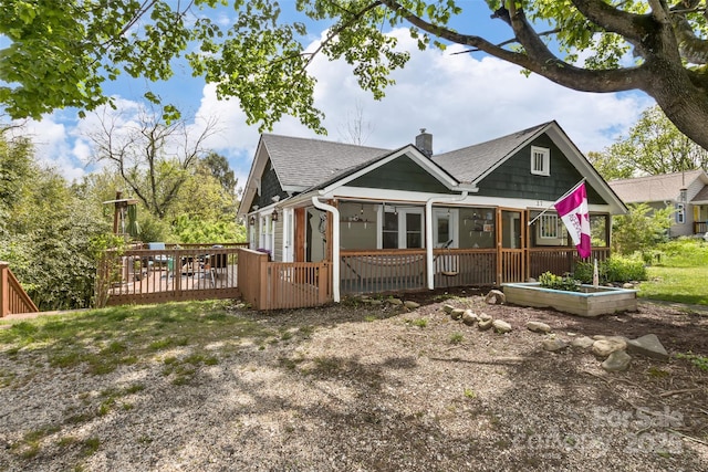 27 Townview Dr, Asheville, NC 28806 - exterior space with a deck, a chimney, a shingled roof, and a sunroom
