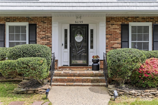 6035 Idlebrook Dr, Charlotte, NC 28212 - view of exterior entry featuring brick siding, a porch, and mansard roof