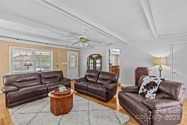 6035 Idlebrook Dr, Charlotte, NC 28212 - living area with wood finished floors, beamed ceiling, a ceiling fan, and brick wall